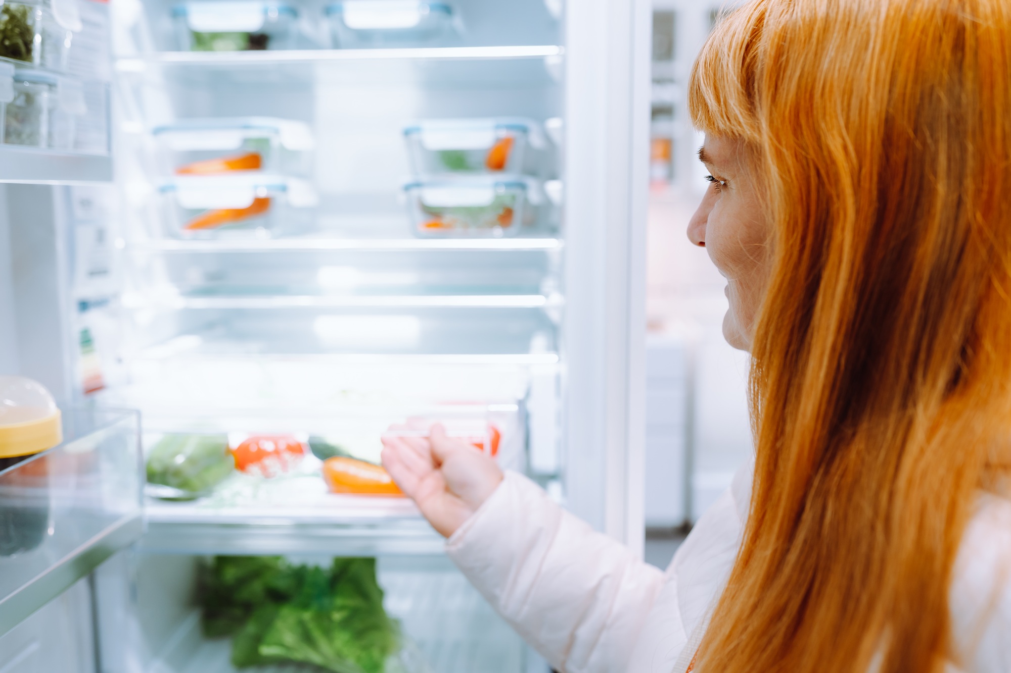 red-haired woman in store household appliances and kitchen utensils